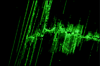 Damaged hollow fibre composite material viewed under UV light shows ‘bleeding’ of the fluorescent dye mixed with the healing resin. Reproduced with permission from ref. 166.