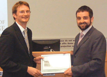 Robert Eagling, editor, presenting the Chem Soc Rev Emerging Investigator Award to Matthew Gaunt (left).