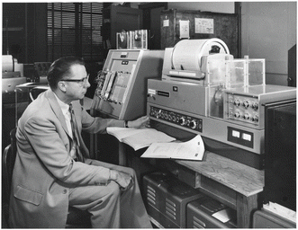 Norman Jones turning knobs on his new toy, the Perkin-Elmer 521 spectrometer, ca. 1967 (personal photograph).