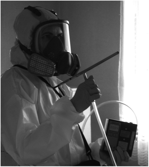 Photograph of the dynamic SPME field sampler being used inside a suspected former clandestine methamphetamine laboratory. The air pump is generally not held during sampling but is housed in a washable carry bag.